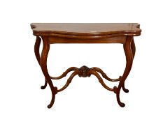 Victorian style mahogany card table of serpentine outline with baize lined fold over top on cabriole