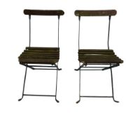 Pair of vintage folding garden chairs with metal frames and slatted wooden seats