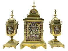Late 19th century continental brass cased striking mantle clock with a pair of matching brass framed