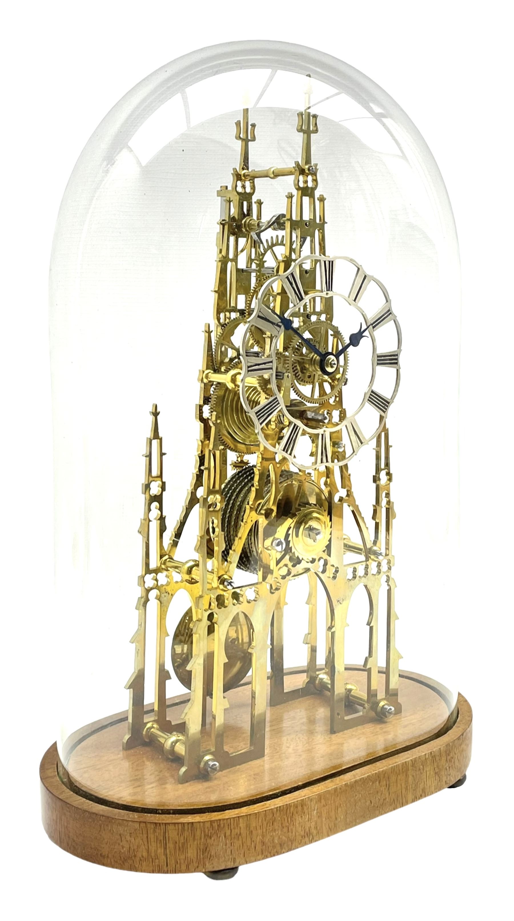 A 20th century seven pillar single train fusee skeleton clock with fretted triple spire movement pla