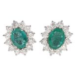 Pair of oval emerald and round brilliant cut diamond cluster stud earrings