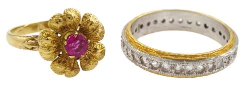 Gold pink stone set flower design ring and a gold clear stone set full eternity ring