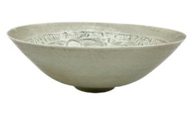 Chinese Ding ware style bowl with inner moulded decoration of figures on raised foot