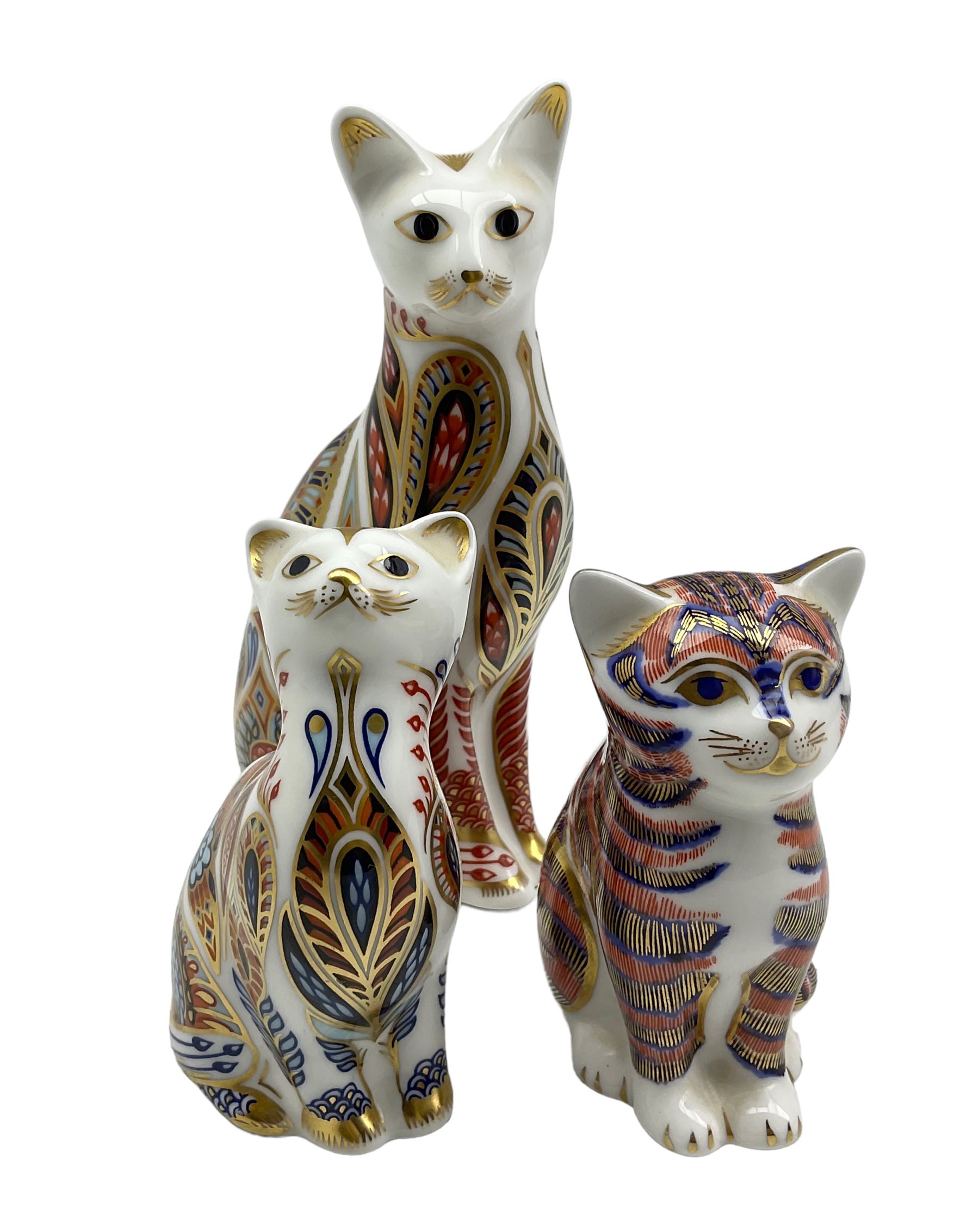 Three Royal Crown Derby paperweights comprising a Siamese cat and kitten dated 1996 and another Cat