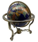 Table top terrestrial globe inset with semi precious stones on a blue ground in metal frame with com