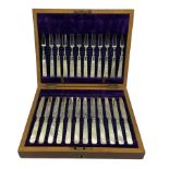 Set of twelve Edwardian dessert knives and forks with engraved silver blades and mother of pearl han