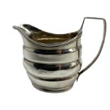 George III silver cream jug with reeded handle and rim