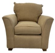 Armchair upholstered in beige fabric