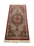 Persian design rug with central medallion in an ivory field