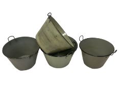 Four painted metal buckets with carrying handles