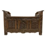 Oak window seat with hinged lifting seat over base with carved Gothic style arches