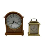 Two 20th century mantle clocks. A light maple wooden cased 8-day mantle clock and a quartz carriage