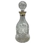 Glass decanter with wide foot featuring silver collar by Mappin and Webb