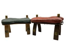 Pair of camel stools with leather seats and Egyptian motifs