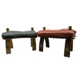 Pair of camel stools with leather seats and Egyptian motifs