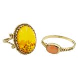Gold single stone coral ring and a old single stone amber ring