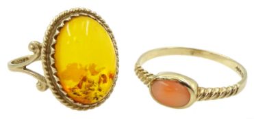 Gold single stone coral ring and a old single stone amber ring