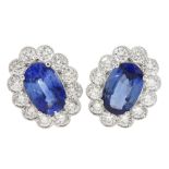 Pair of 18ct white gold milgrain set oval sapphire and round brilliant cut diamond stud earrings