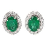 Pair of 18ct white gold oval emerald and round brilliant cut diamond cluster stud earrings