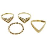 Three gold wishbone rings and one other gold twist ring