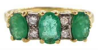 18ct gold three stone oval emerald and four stone diamond ring