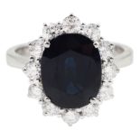 18ct white gold oval sapphire and round brilliant cut diamond cluster ring