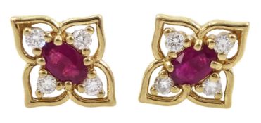 Pair of 9ct gold oval ruby and round brilliant cut diamond flower design stud earrings