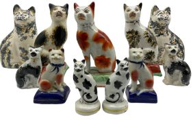 Three Victorian style Staffordshire pottery cat ornaments seated on cushions H17cm