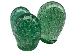Victorian green glass dump paperweight with elongated bubble inclusions H15cm and two other very sim