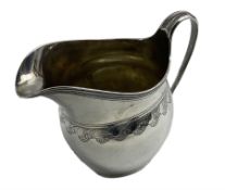 George III silver cream jug with engraved cartouche and trailing border pattern with reeded loop han