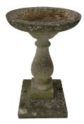 Reconstituted bird bath raised on a square stepped base