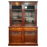 Late 19th century walnut bookcase on cupboard
