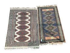 Kilim pattern rug with a centre lozenge design on beige field with multi stripe border