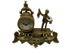 20th century cast brass mantle clock with a circular drum movement accompanied by a figure of a youn