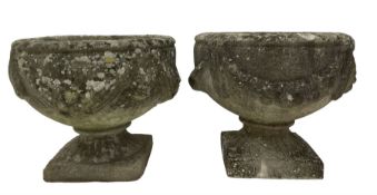 Near pair of garden urns with swags