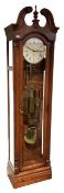 A 20th century American floor standing �tall case clock� with a swan's neck pediment and full-length