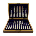 Mother of pearl handled silver plate fruit knives and forks in oak case with blue velvet lining W32c