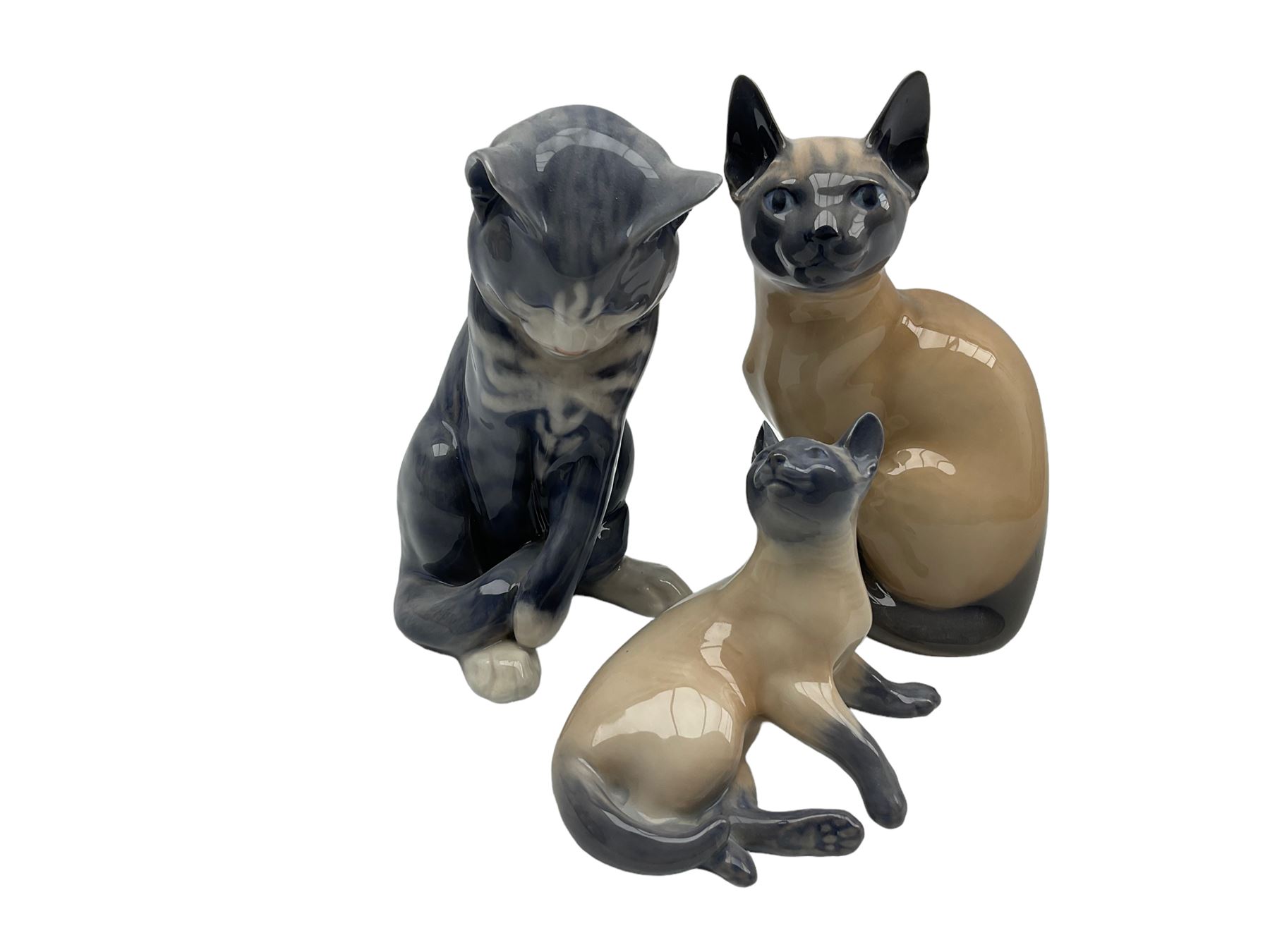 Two Royal Copenhagen Siamese cat models No.3281 and no. 2862 together with another Royal Copenhagen