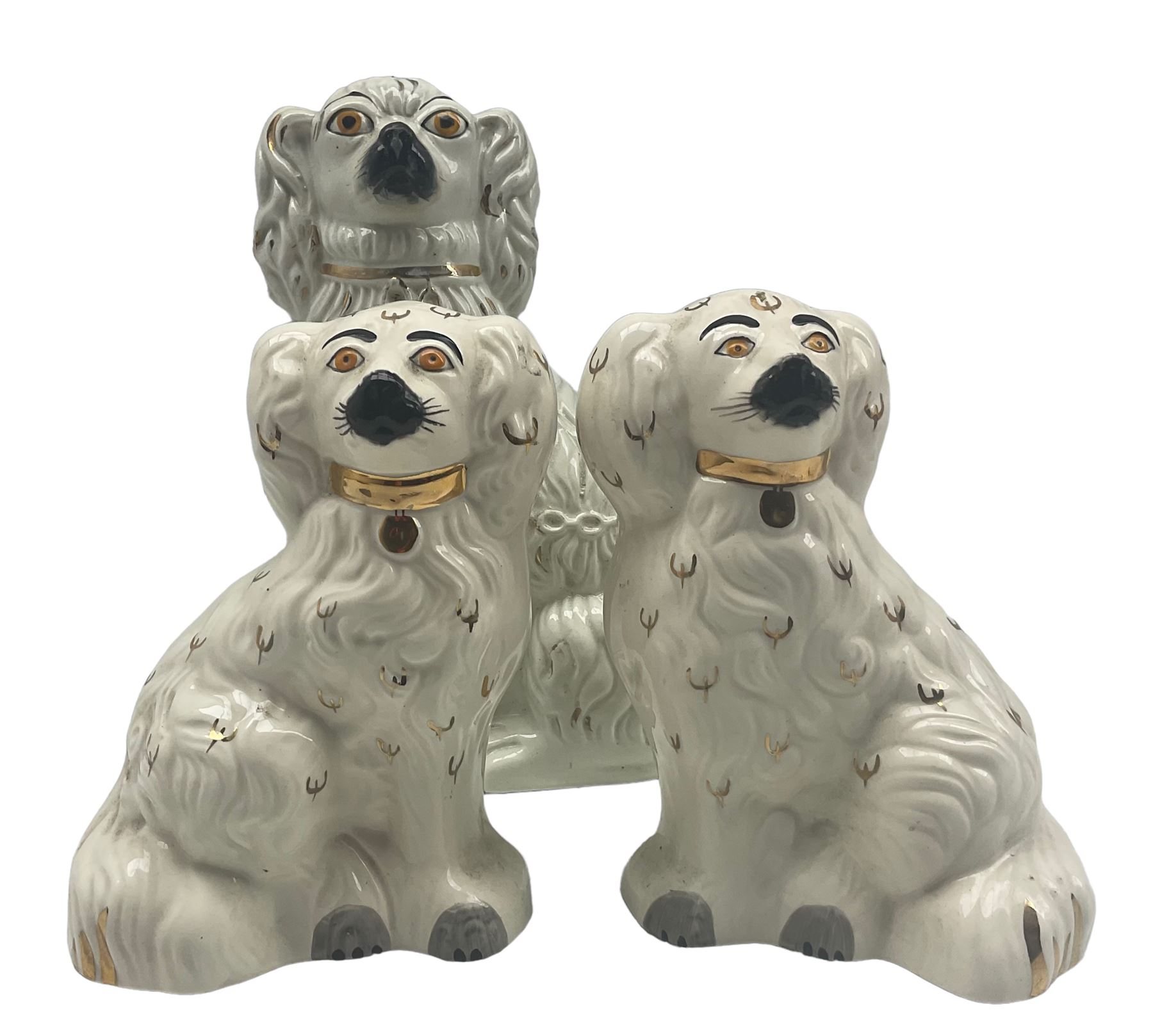 Staffordshire pottery spaniel with chain and gilding together with pair of Staffordshire style Beswi