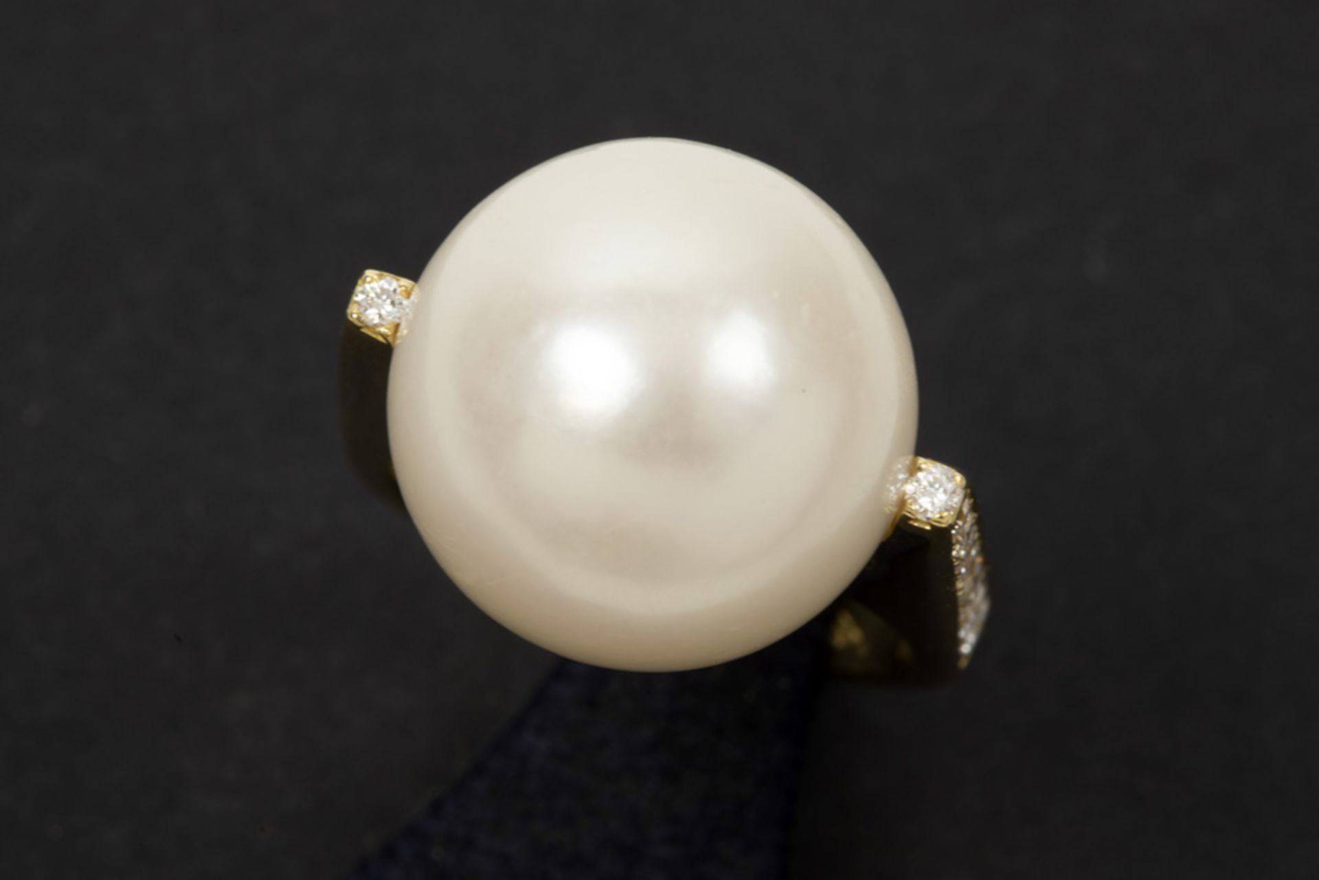 large pearl with nice lustre set in a ring in white gold (18 carat) with ca 0,30 carat of very