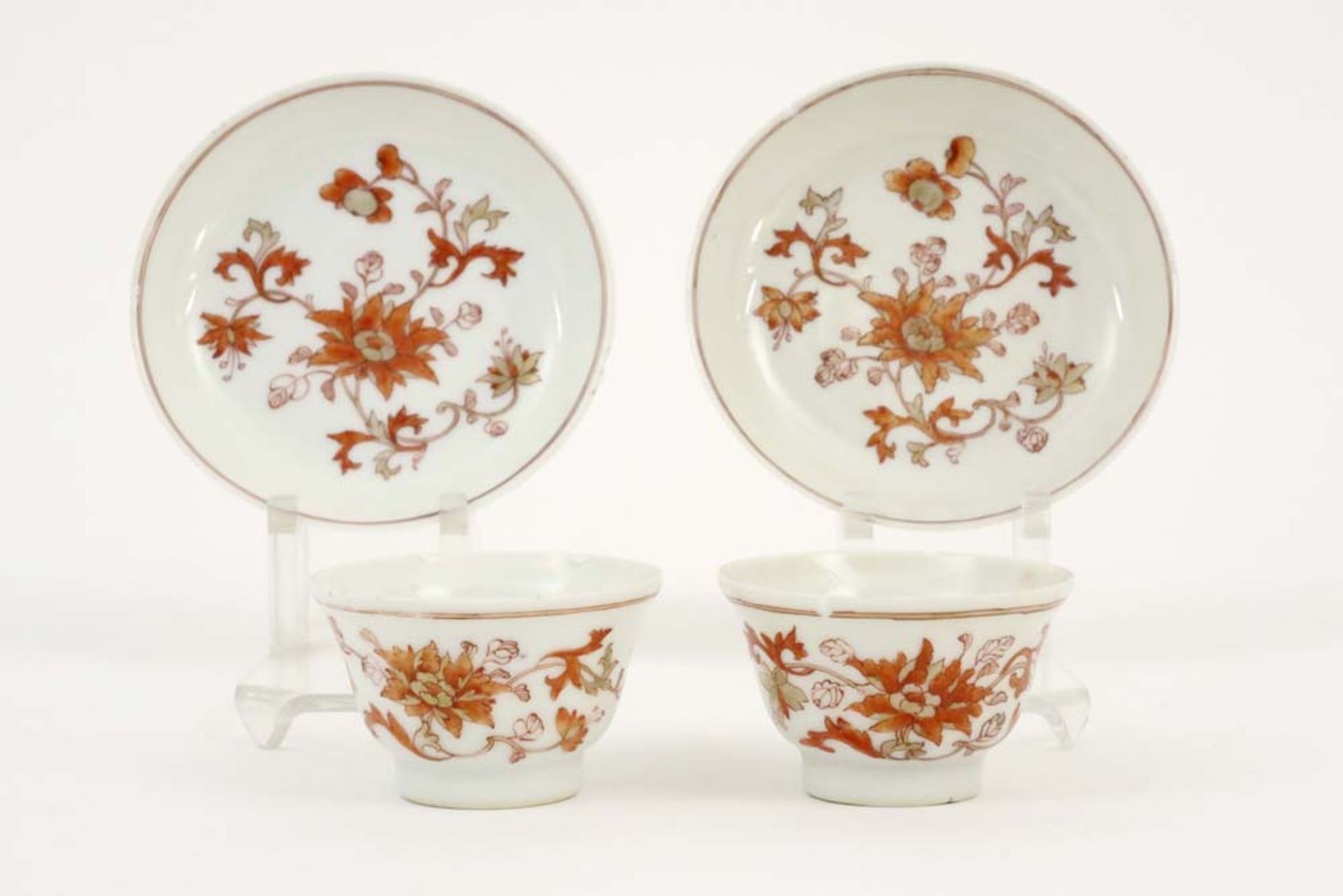 two 18th Cent. Chinese sets of cup and saucer in porcelain with a flower decor in sanguine colors