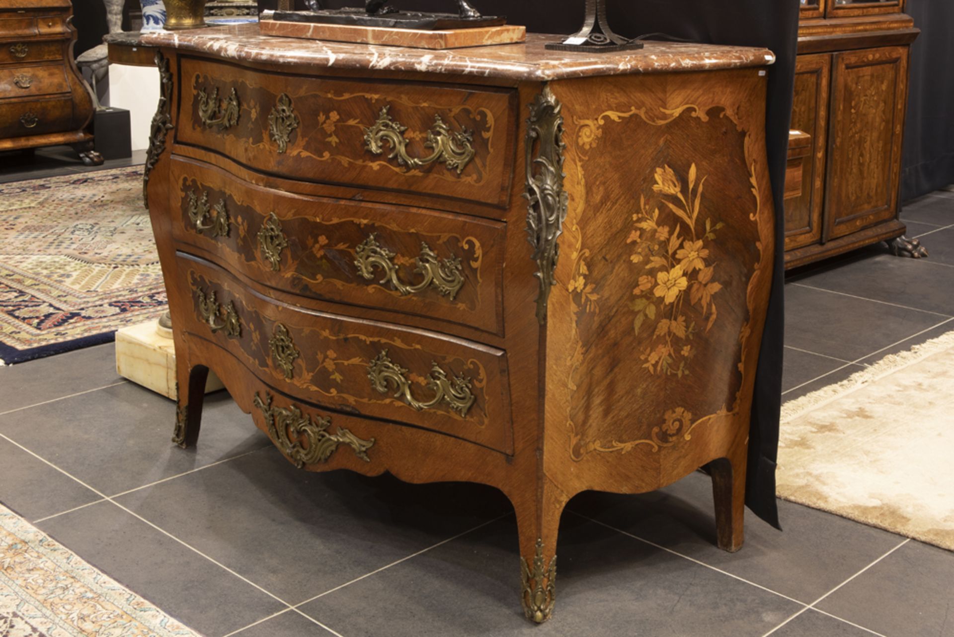 antique French Louis XV style chest of drawers in marquetry with mountings in gilded bronze and with