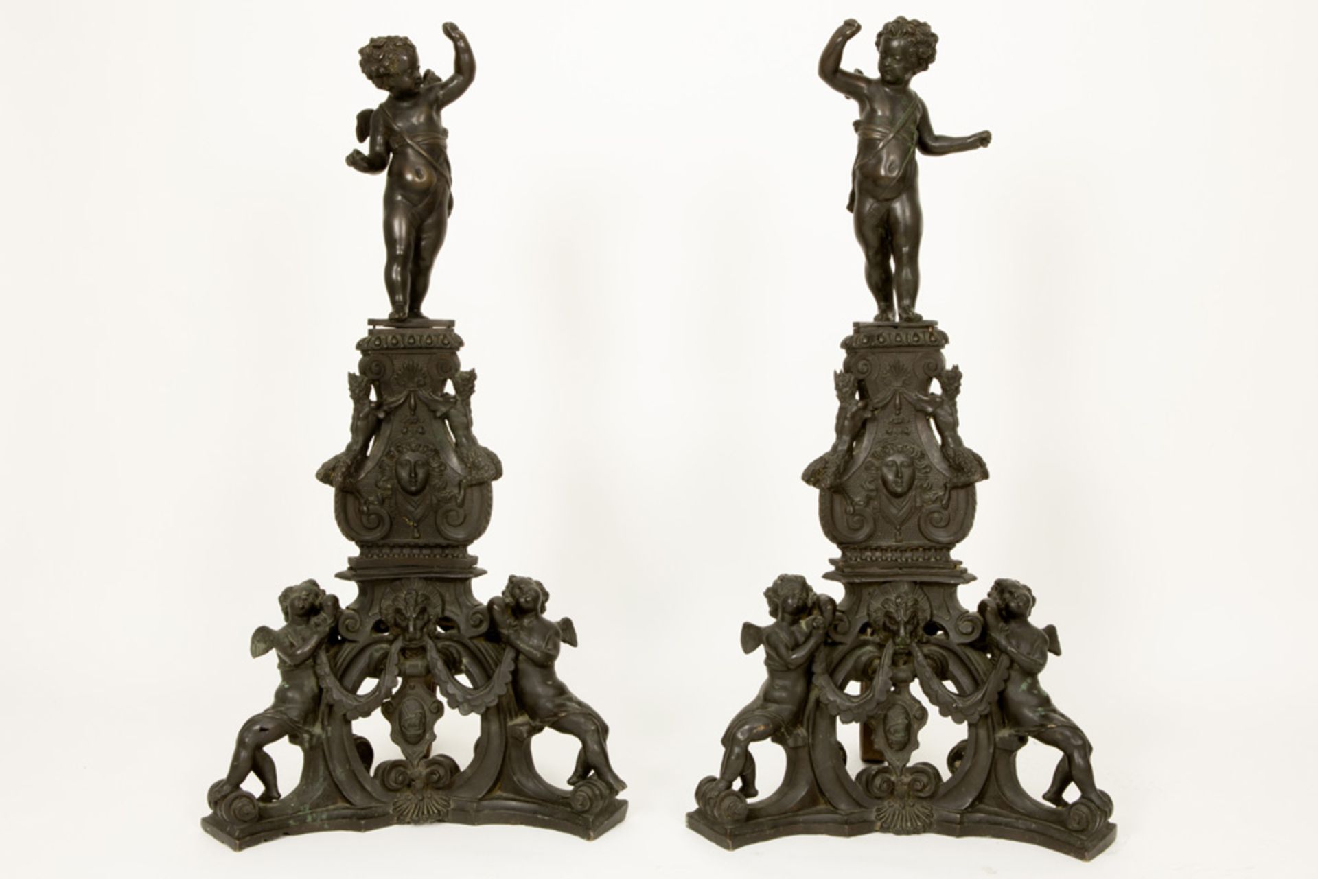 exceptional pair of 19th Cent. large (106 cm high ! ) bronze andirons each with a cupid on a