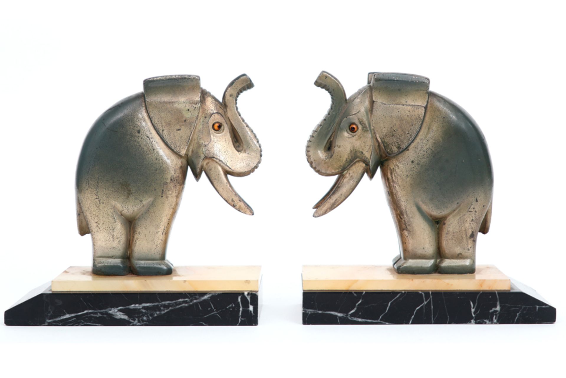pair of Art Deco book-ends each with a cute elephant in patinated metal on a base in marble and
