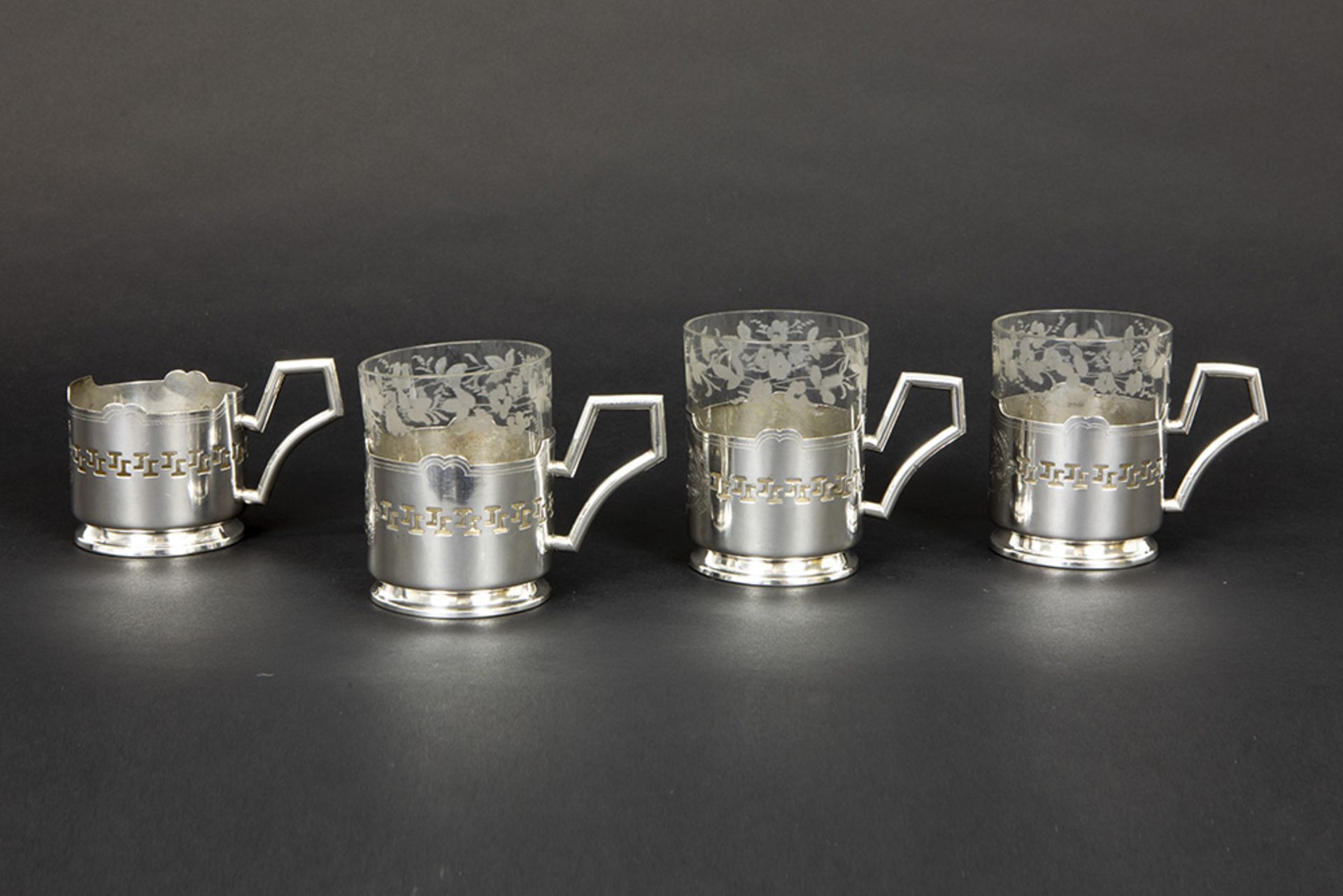 four antique tea-glass holders in marked silver (three with glass cup) || JS set van vier Poolse