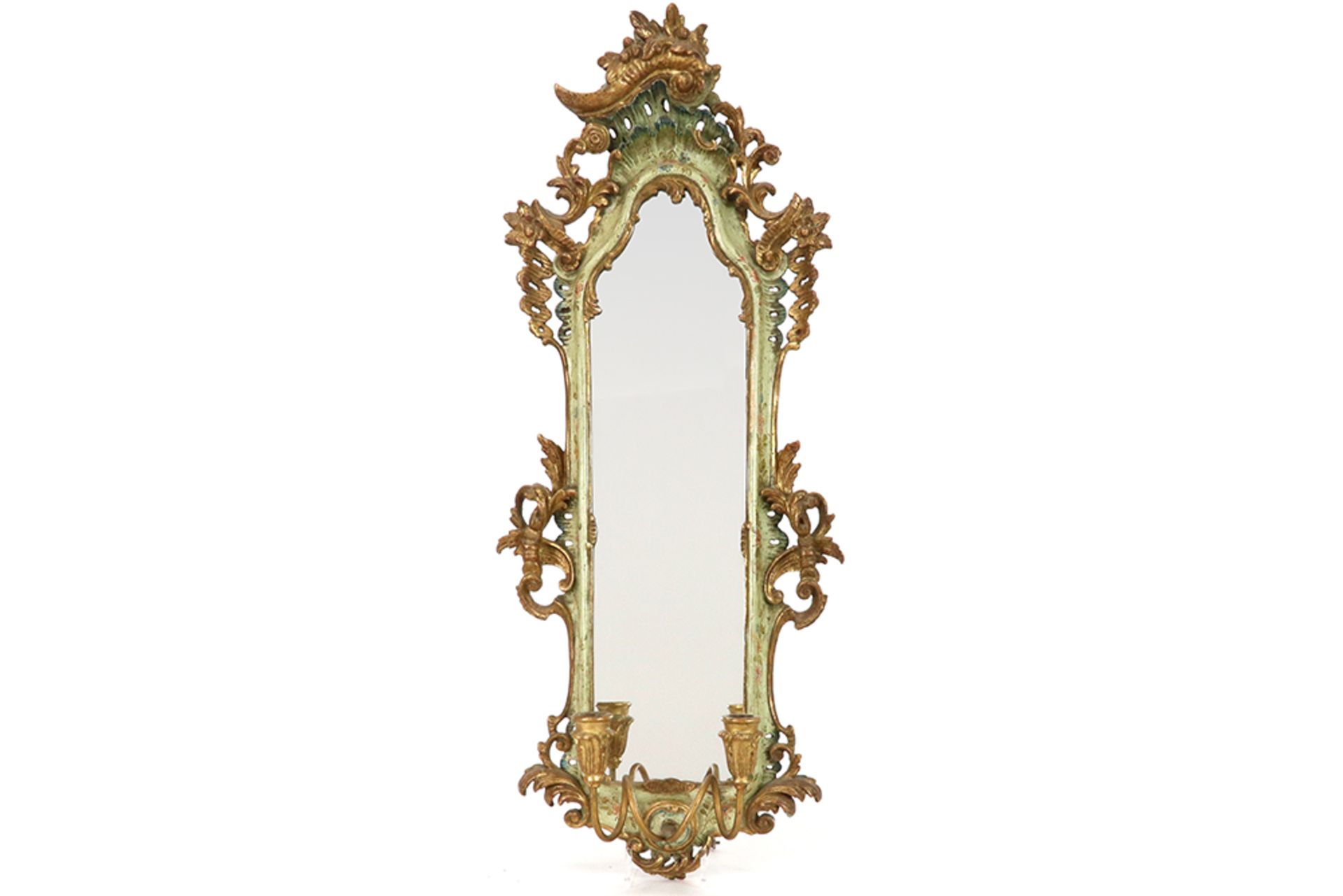 mirror with an antique Venetian frame in finely sculpted wood with typical polychromy || Spiegel met