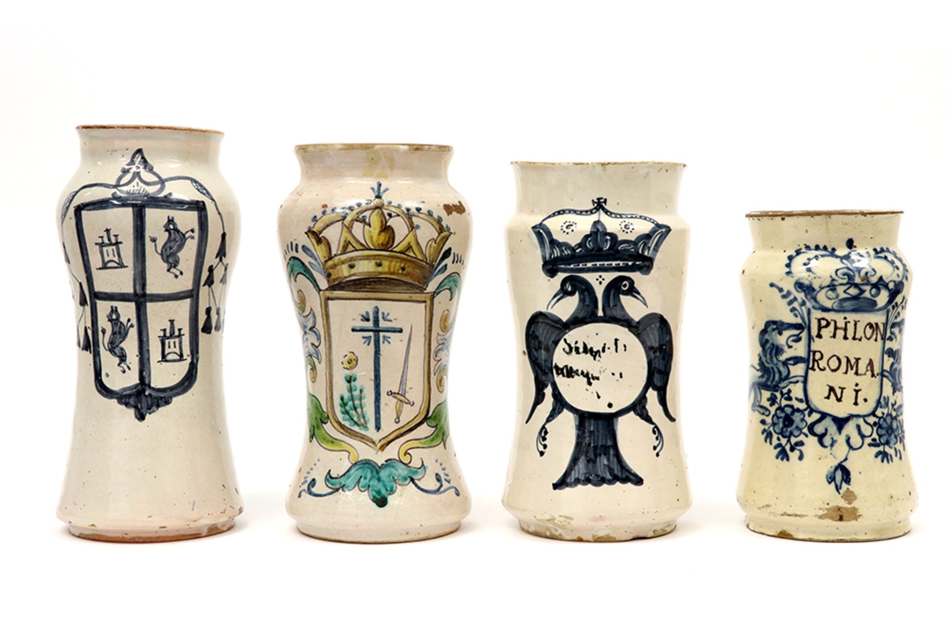 four antique, maybe Spanish, pharmaceutical jars in ceramic, three with a blue-white and one with
