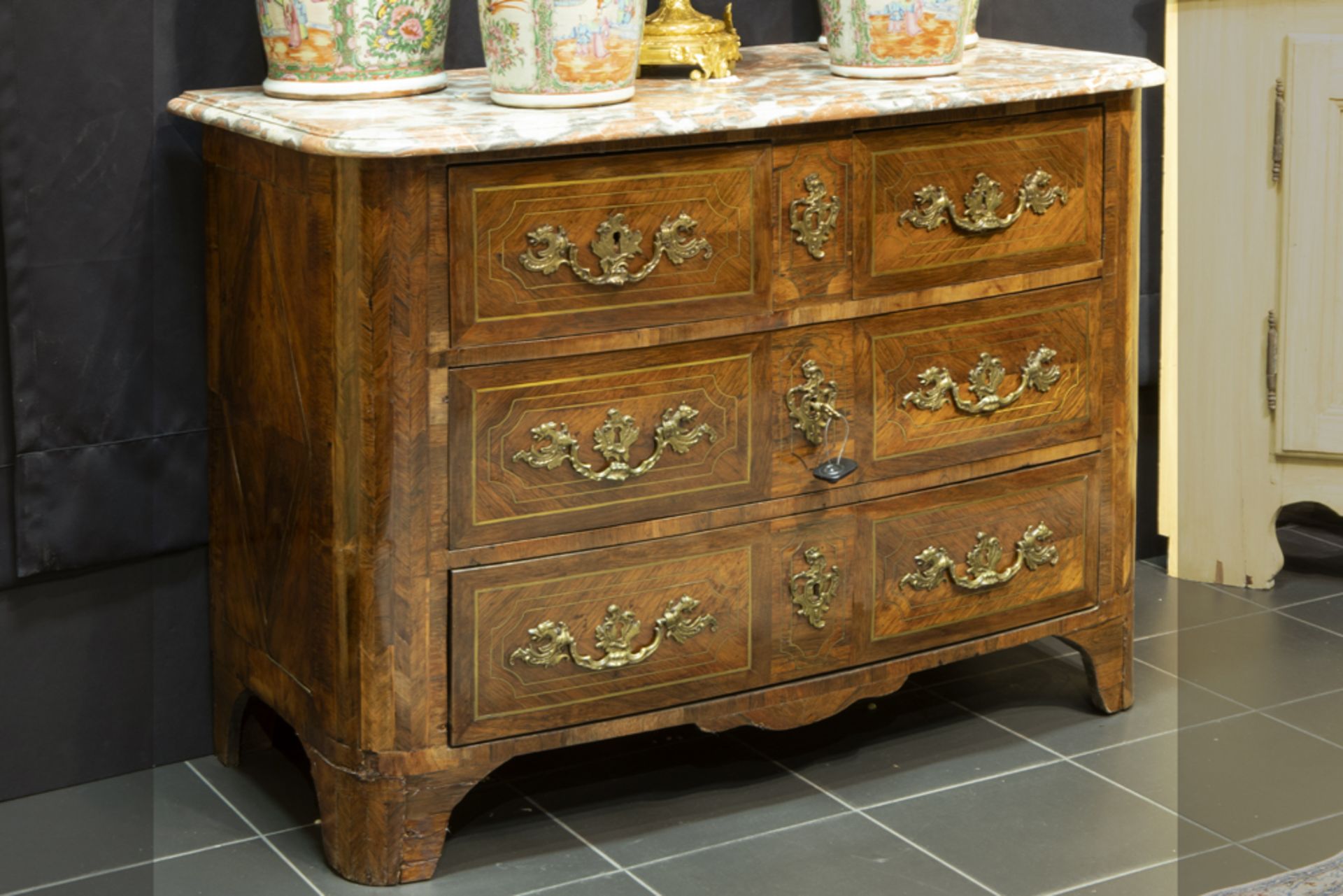 18th Cent. chest of drawers in parquetry with brass inlay, with four drawers with original mountings