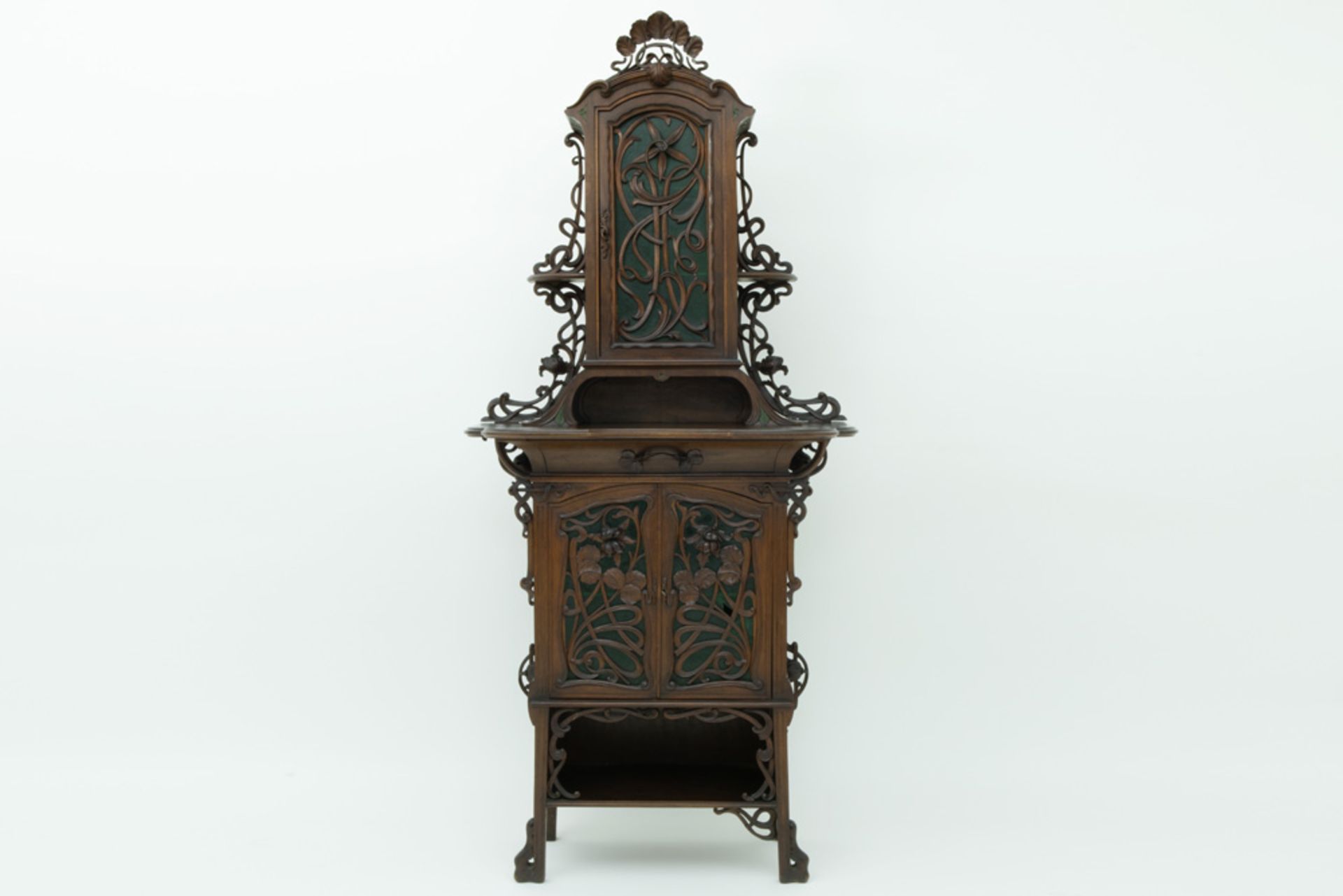 French Art Nouveau display cabinet in walnut with four doors, open compartments and whatnots,
