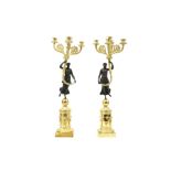 pair of Empire style candelabra in partially gilded bronze each with a typical female figure || Paar